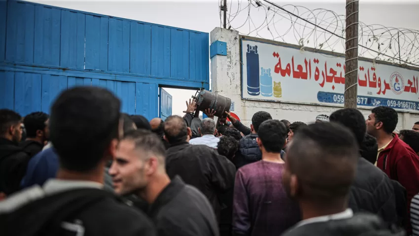 Cientos de palestinos esperan frente a un centro de distribución para recibir comida
